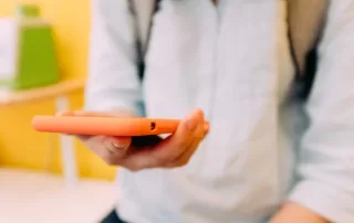 a person holding a carrot in their hand