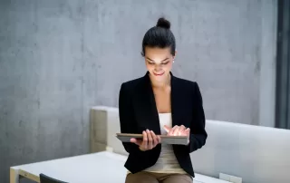 a woman in a suit holding a piece of paper