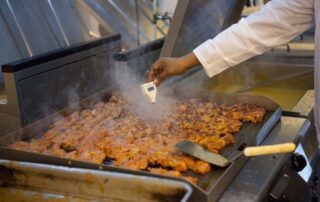 A restaurant employee cooking food