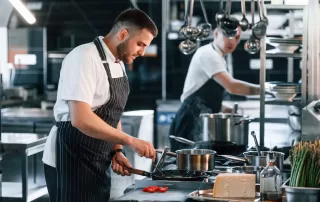 two chefs working in kitchen